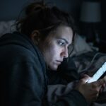 woman scrolling symptoms on a phone