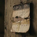 A torn calendar page held past its final day by a strip of tape — representing a continuing resolution, the stopgap that keeps government funding going.