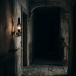 A single gas lamp flickering low in a dim hallway, shadows creeping inward &mdash; representing gaslighting, a sustained pattern of making someone doubt their own perception.